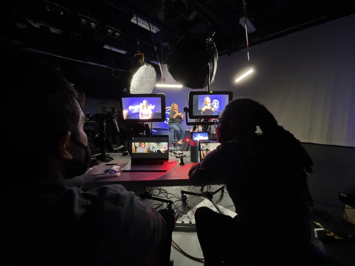 Monitors and crew at video village during a studio interview