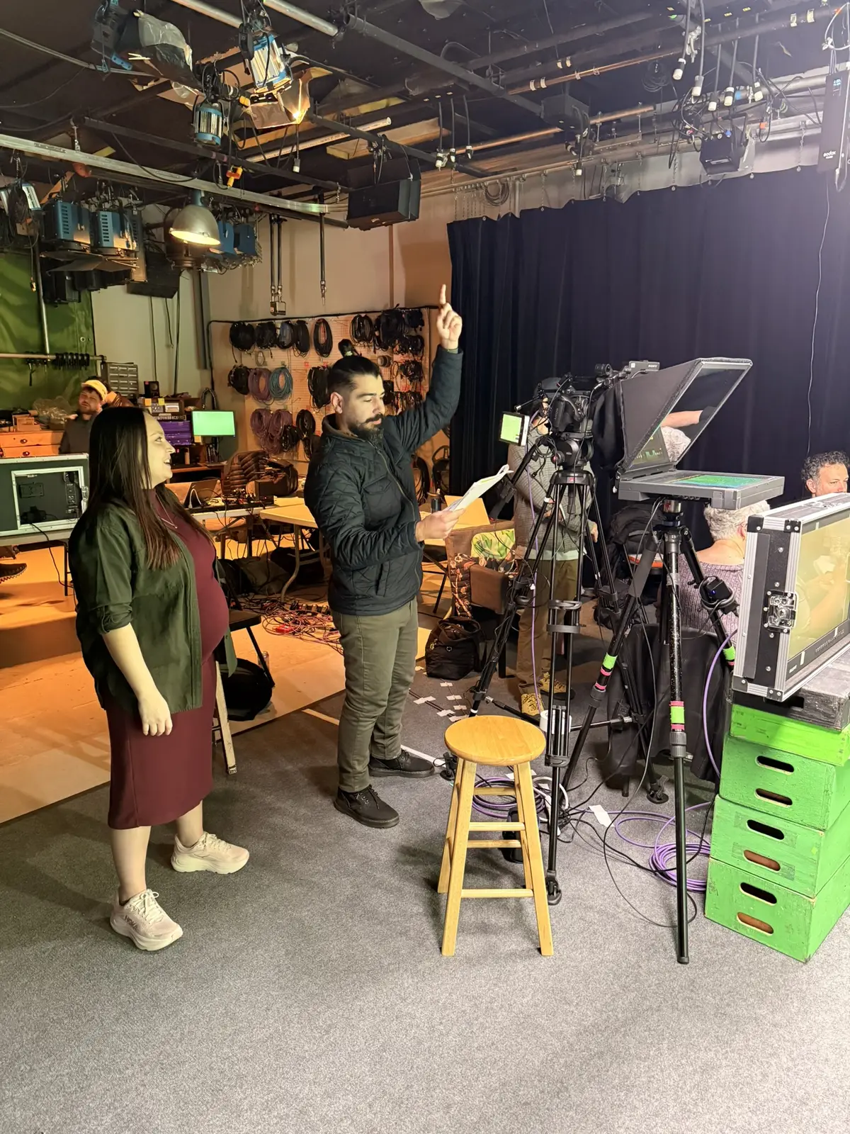 Javier directing an interview subject in a television studio